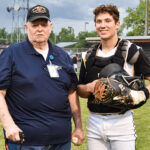 Catcher Ethan Williams posing with a Shasta County Veteran after throwing out the ceremonial first pitch, June 04th, 2022
