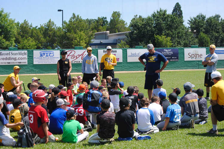 Colt 45s players and coaches talking to a group of kids in center field at Tiger Field. [Formatted]